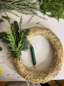 Green foliage wired to straw base