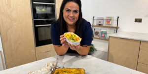 Trisha Lewis holding fish pie in kitchen