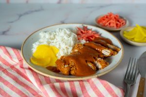 Chicken katsu curry in bowl with striped tablecloth