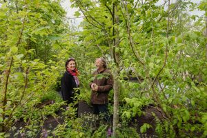 kerrie gardiner and oliver schurmann smiling and laughing beside trees