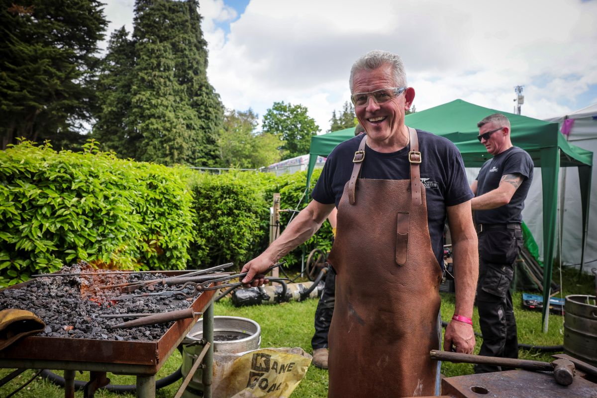 Blacksmith smiling and working